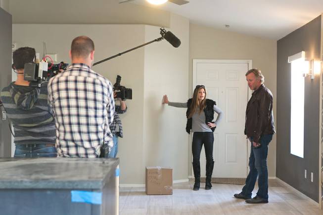 Scott and Amie Yancey, from A&E’s “Flipping Vegas,” check on progress of one of their remodeling projects during a taping of their show Tuesday, Nov. 26, 2013.